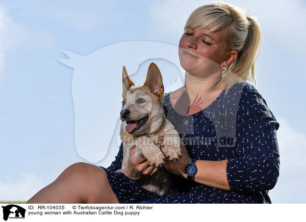 young woman with Australian Cattle Dog puppy / RR-104035