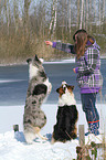 woman with 2 dogs in the snow