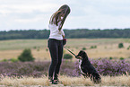 young woman with Miniature Australian Shepherd