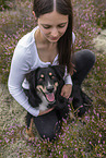 young woman with Miniature Australian Shepherd