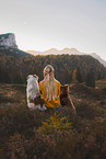 young woman with 2 Miniature Australian Shepherds