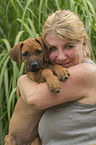 woman with Rhodesian Ridgeback puppy
