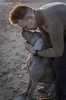 man and Weimaraner