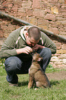 man and mongrel puppy