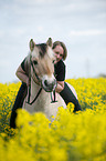 woman rides Fjord horse