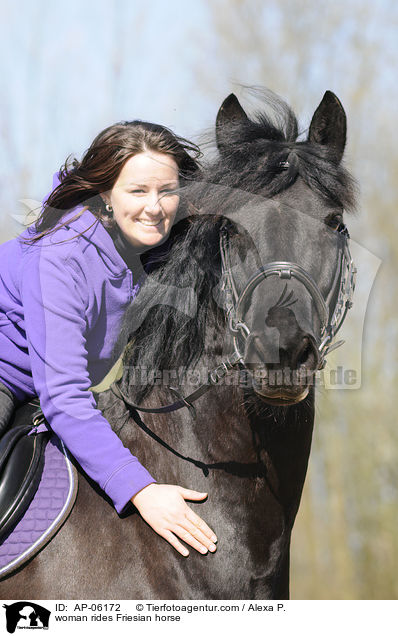 woman rides Friesian horse / AP-06172