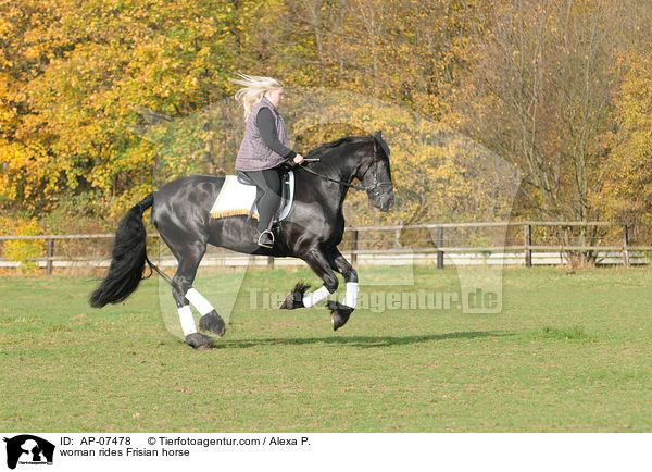woman rides Frisian horse / AP-07478