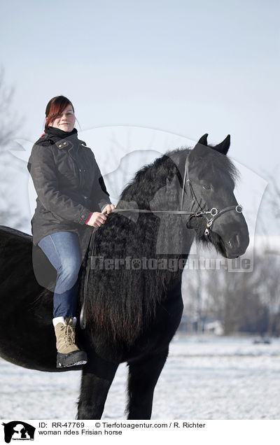woman rides Frisian horse / RR-47769