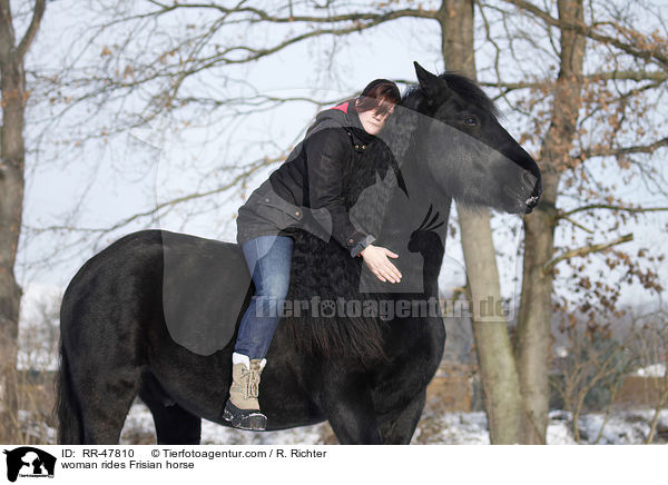 woman rides Frisian horse / RR-47810