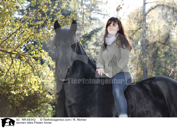 woman rides Frisian horse / RR-58342