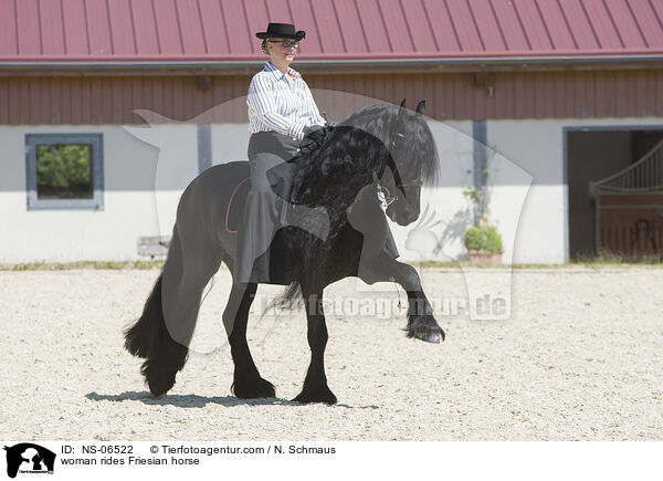woman rides Friesian horse / NS-06522