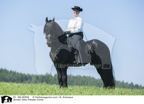 woman rides Friesian horse / NS-06558