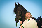 man and Frisian horse