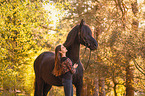 girl and Frisian horse