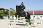 woman rides Friesian horse