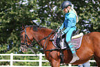 woman rides German Riding Pony