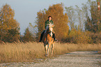 woman rides haflinger horse