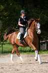 woman rides Hessian Warmblood