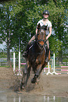 woman rides Holsteiner horse