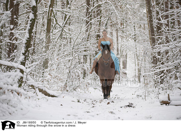 Woman riding through the snow in a dress / JM-18950