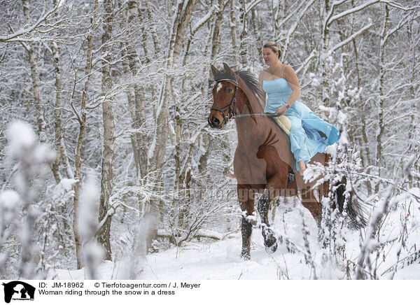Woman riding through the snow in a dress / JM-18962