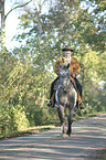 man rides Appaloosa-Mix